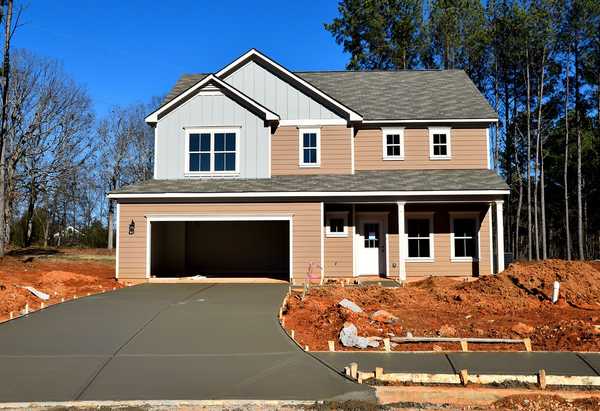 Freshly poured concrete driveway in front of a home